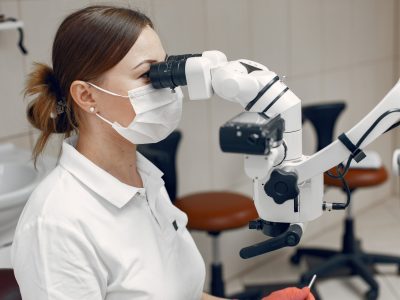 Female doctor in medical mask. Doctor conducts an examination.The woman conducts a microbiological study